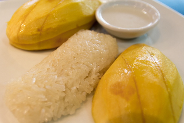Ripe Mango served with Sweet Sticky Rice and Topped with Coconut Milk